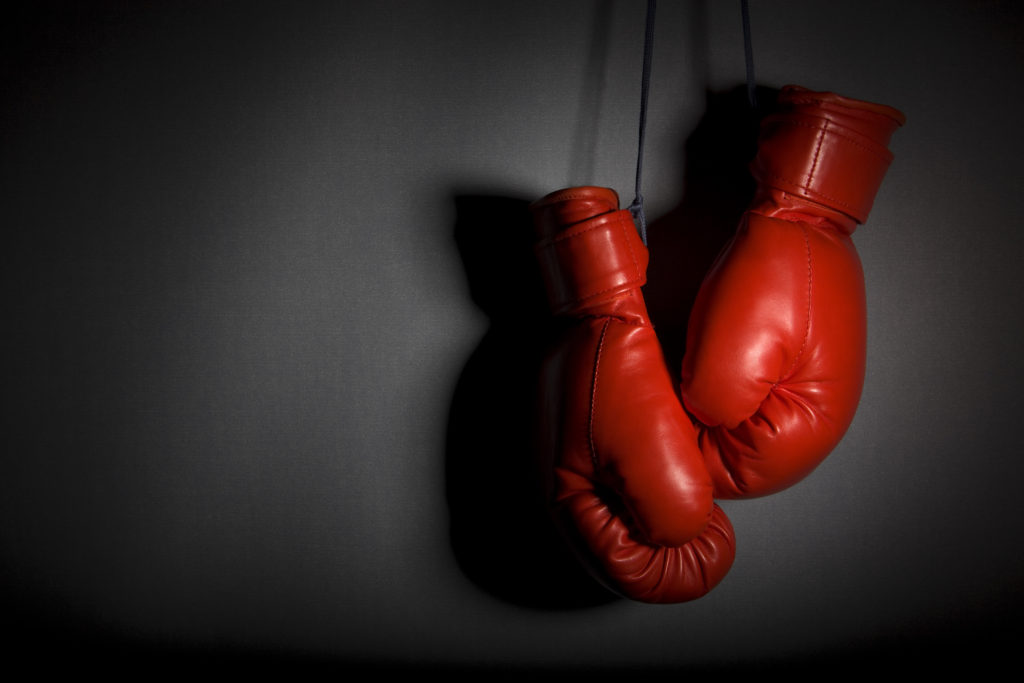 Hanging boxing gloves. Very low key and heavy shadows
